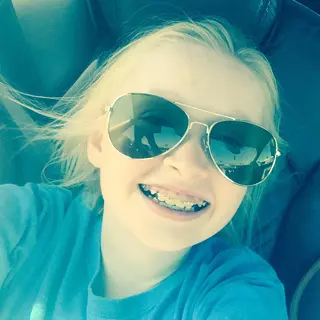 Maya with her family smiling